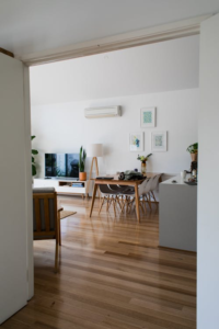 Interior of a modern lounge with contemporary furniture, featuring an air conditioning system.