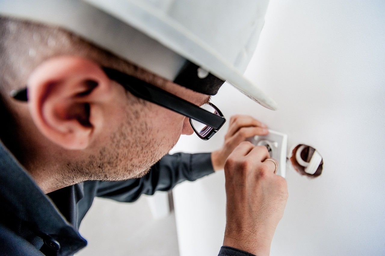 a person fixing the switchboard