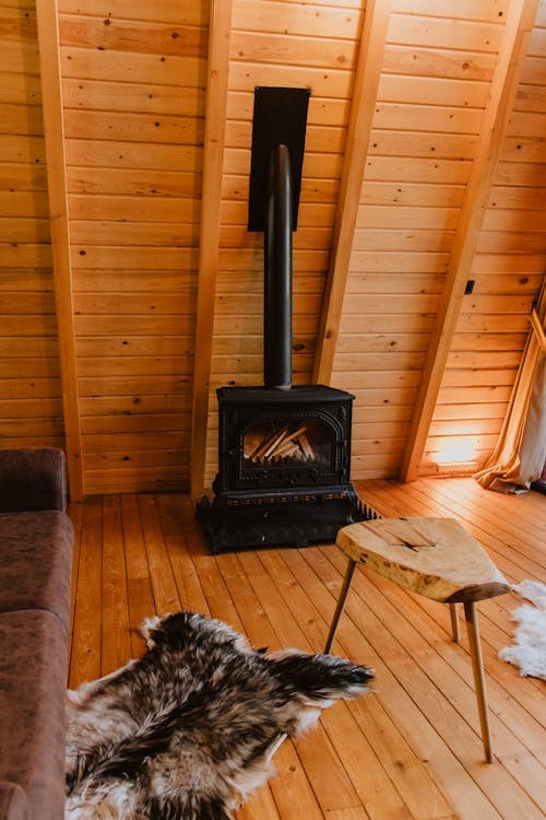 A furnace inside a wooden cabin.