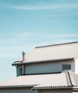 House with a light-colored metal roof and gutter system