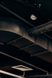  Industrial HVAC ductwork and ceiling vent system in a commercial building.